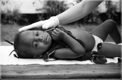 Young child getting medical treatment representing the Village Foundations healthcare projects
